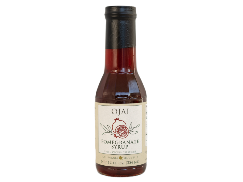 Bottle of Ojai Pomegranate Syrup on a white background